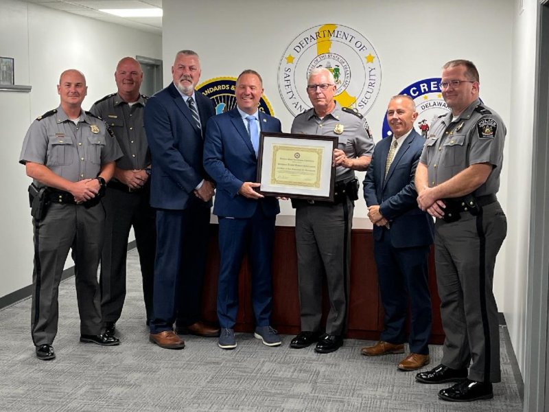 Working together during the reaccreditation process were (l-r) Maj. Aaron Bonniwell, Cpl. Keith Shyers, DPAC Accreditation Administrator John Feehan, DSHS Cabinet Secretary Joshua Bushweller, DATE Director John Yeomans, POST Executive Director Sean E. Moriarty, EdD, and DATE Deputy Chief Kevin Jones.